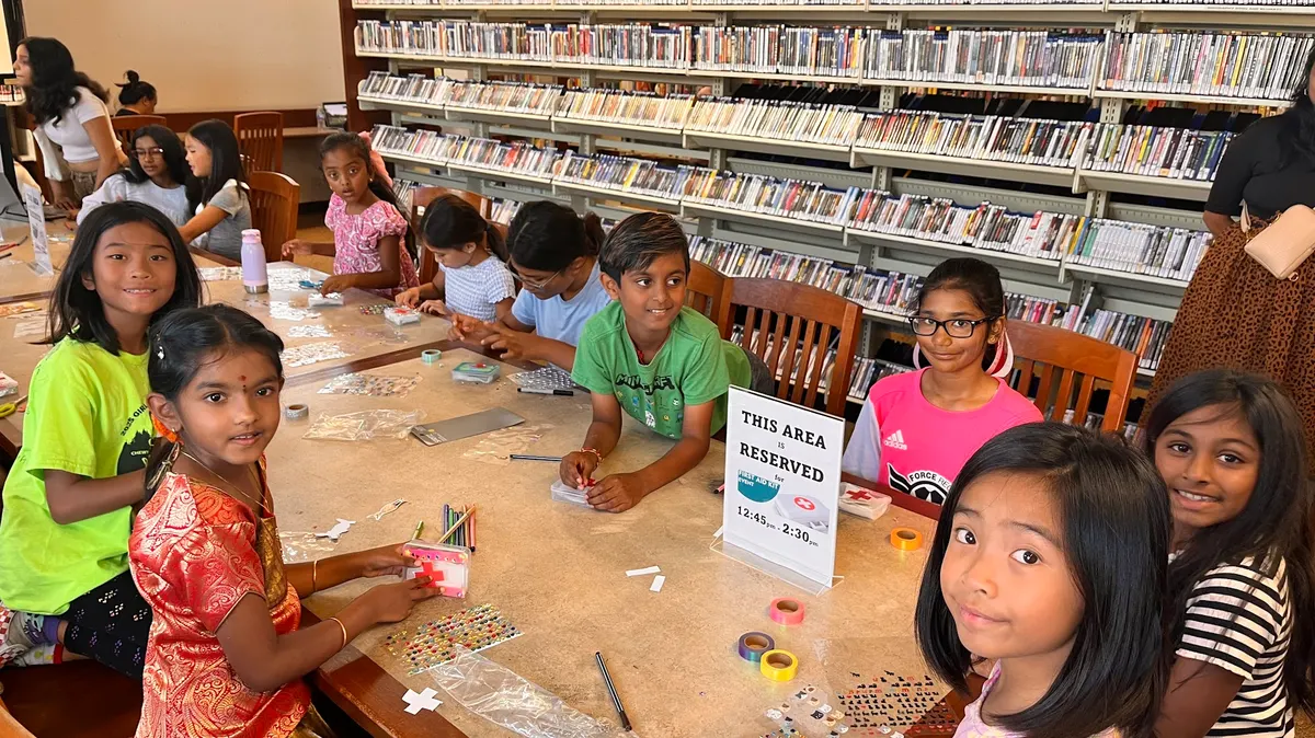 Children at a library table decorating cards for hospitalized patients