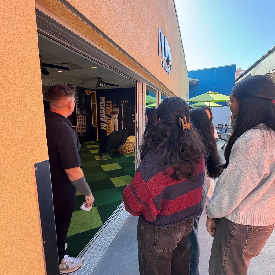 A staff member showing the team around the Padres Clubhouse