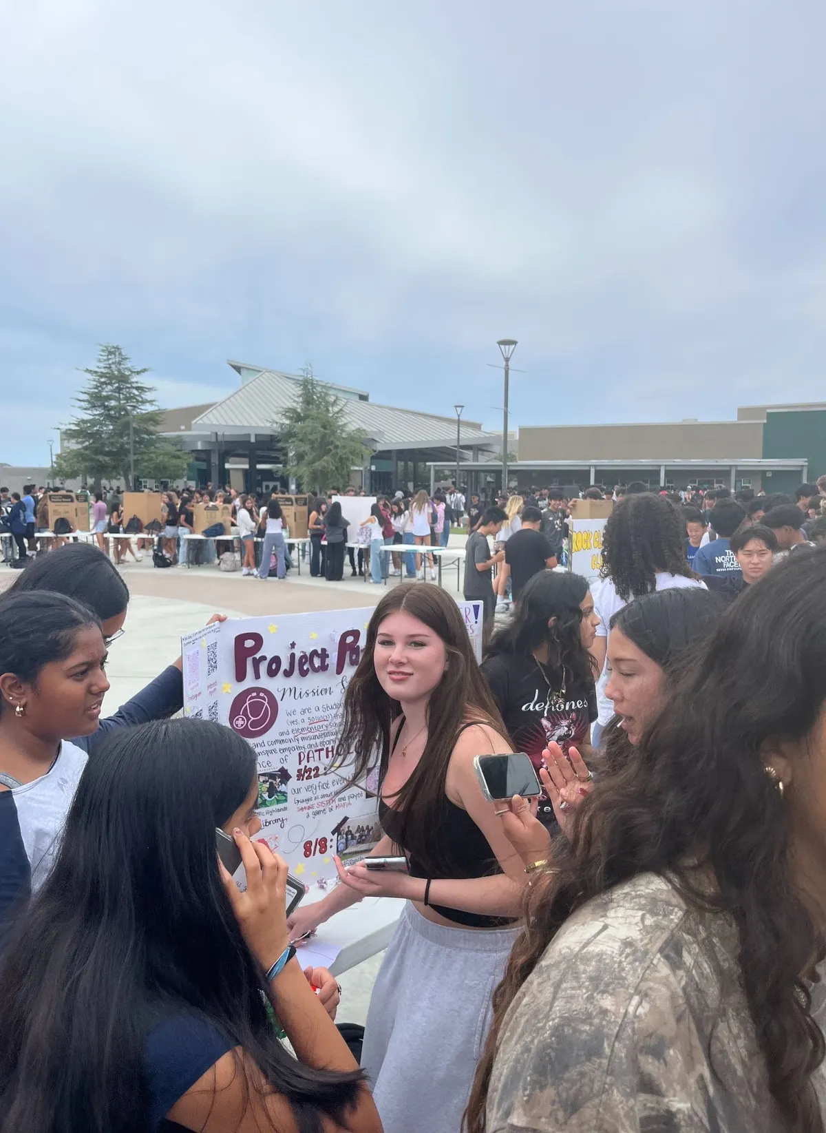 Students crowd around the ProjectPatho booth during Club Rush