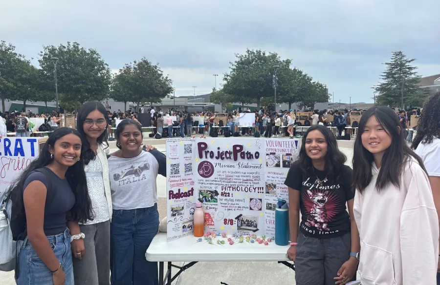 ProjectPatho members behind their Club Rush table at Del Norte High School