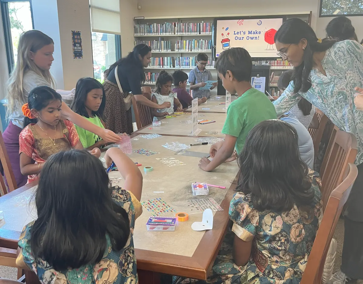 Children packing and decorating their own first aid kits at the library