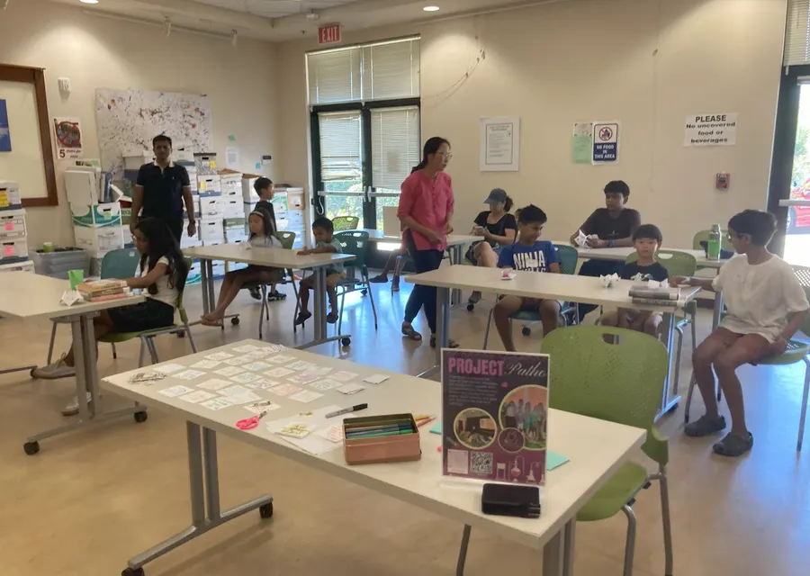 Children at the activity tables with the ProjectPatho sign