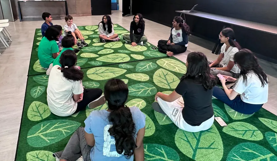 Volunteers and children gathered on the carpet during the game