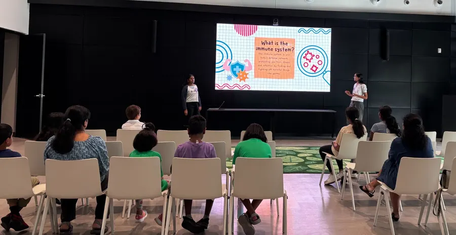 Children seated facing the screen during the presentation