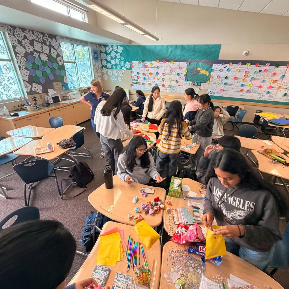 Del Norte club members filling care packages at classroom desks