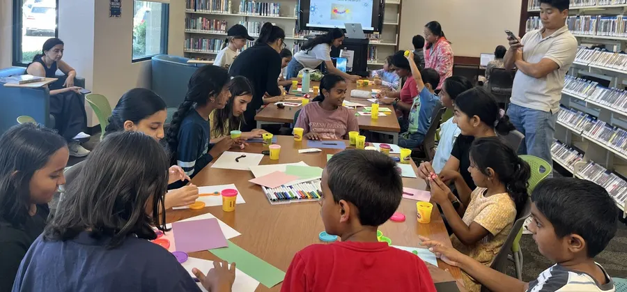 Children working on their neuron models at the table