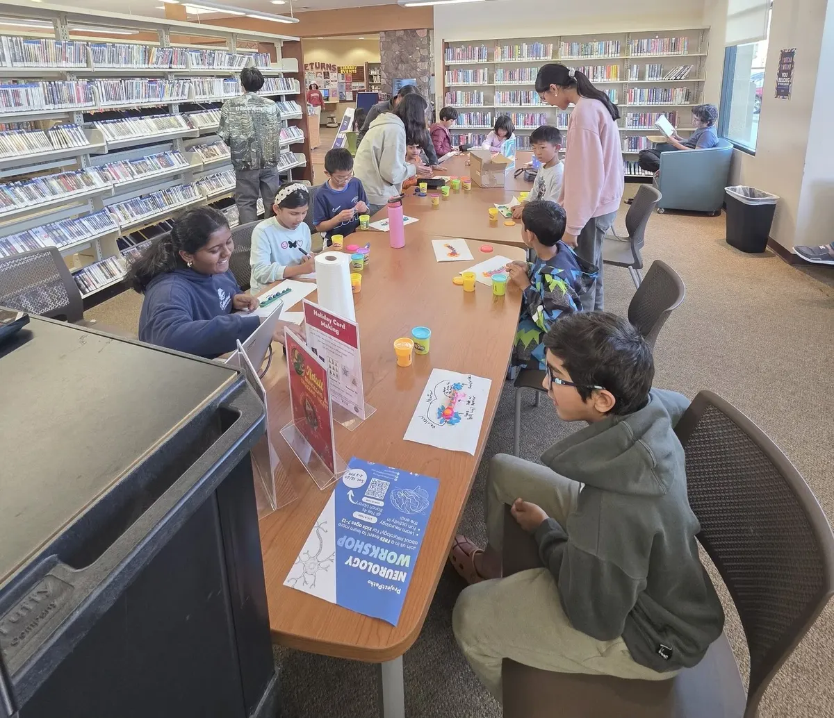 Children at the library table at the start of the neurology workshop