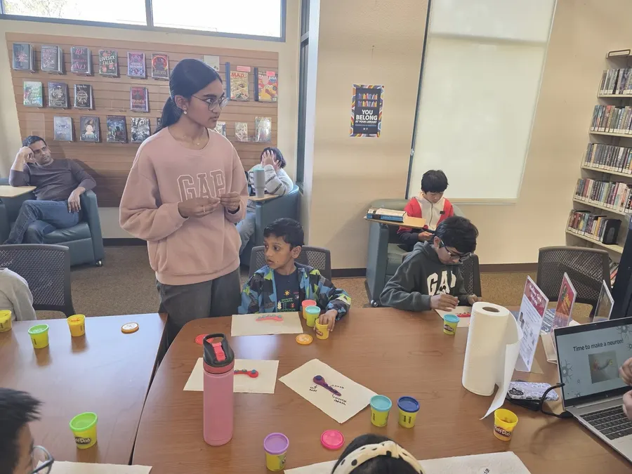 Children shaping their neurons with colored clay